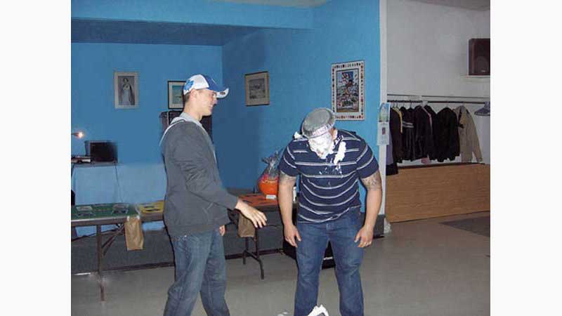 Stag and Doe, ,DJ Barrie, man laughing groom bent over forward with face cover in whip cream and pie plate on his face. Taken in Barrie Ontario